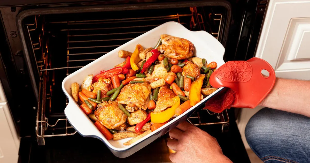 A person presents a dish of freshly baked food from the oven, emphasizing the theme of Oven Meals.